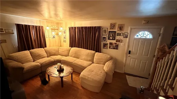a living room with furniture a lamp and a window