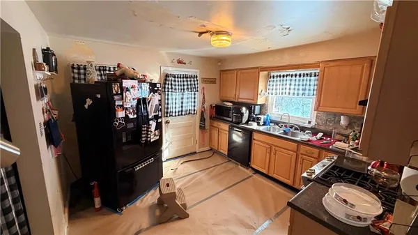 a kitchen with a sink stove and refrigerator