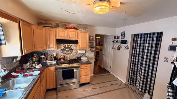 a view of a kitchen with fridge and window
