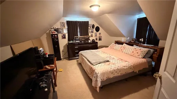 a bed room with a bed and a television