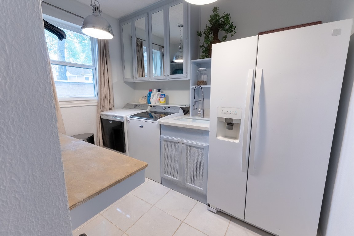 7710 Painton Lane Spring, TX 77389 - Photo 24 of 50 Laundry room boasts extra deep sink & large side by side refrigerator and built in folding table