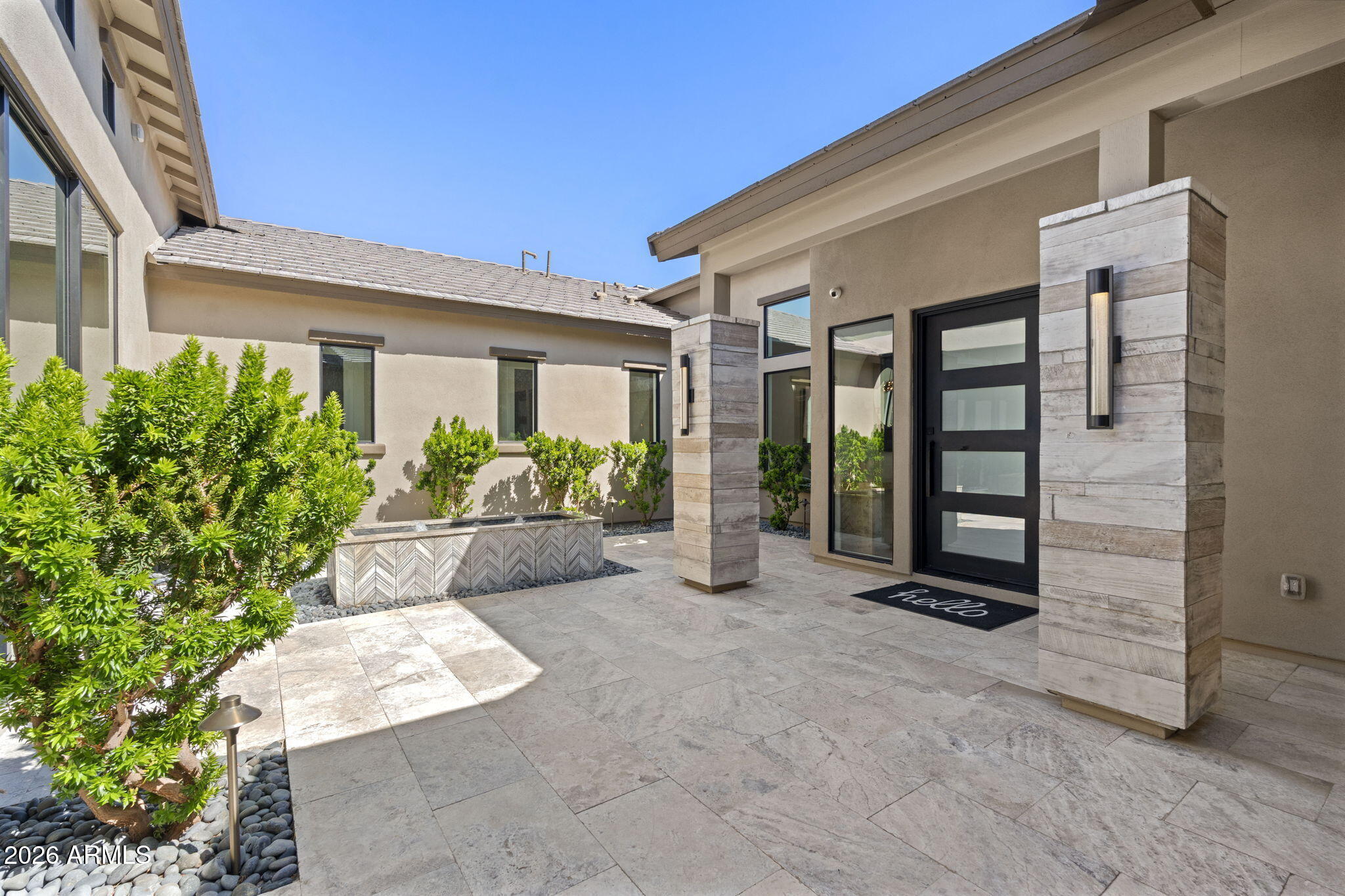 13267 East Ranch Gate Road Scottsdale, AZ 85255 - Photo 12 of 84 front view of a house with a potted plant and floor to ceiling window