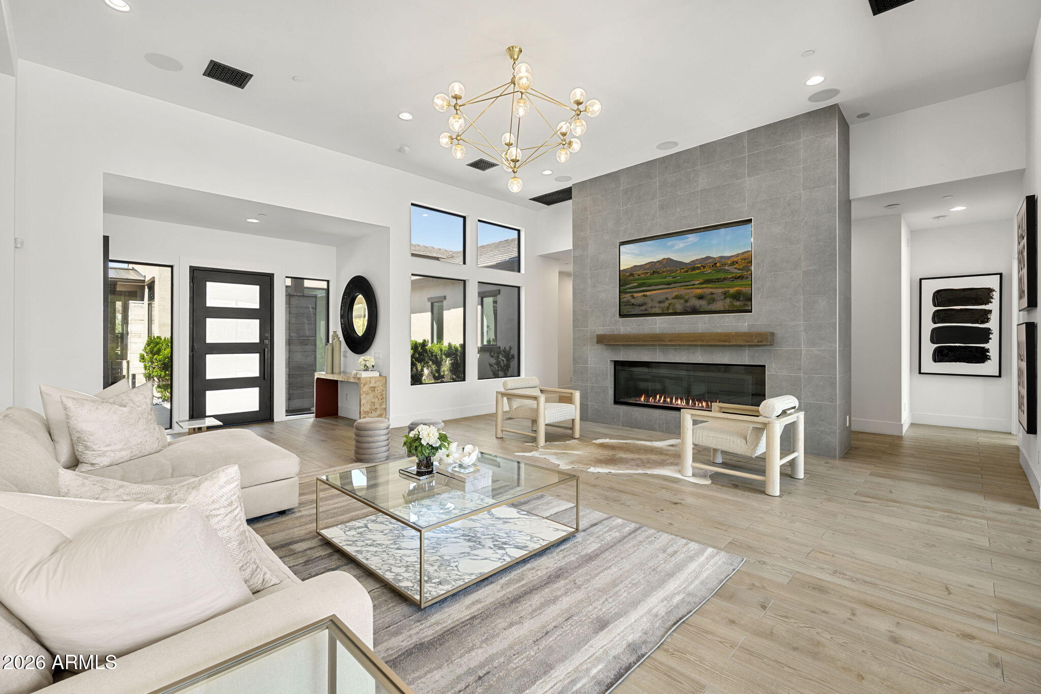 13267 East Ranch Gate Road Scottsdale, AZ 85255 - Photo 19 of 84 a living room with furniture a fireplace and a flat screen tv