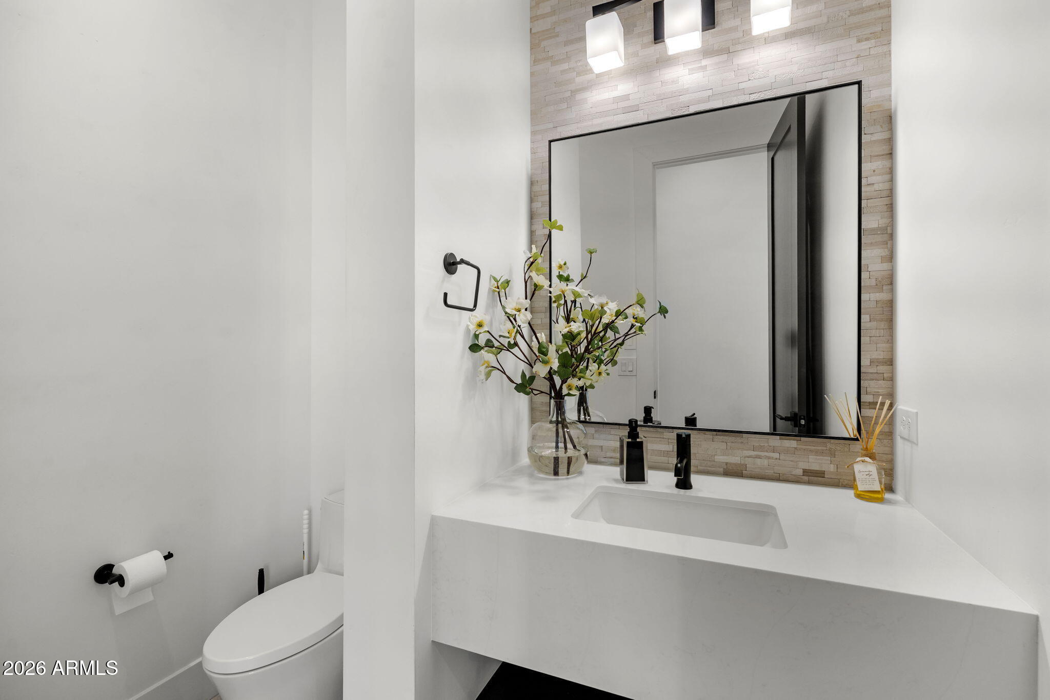 13267 East Ranch Gate Road Scottsdale, AZ 85255 - Photo 45 of 84 a bathroom with a toilet a sink and mirror
