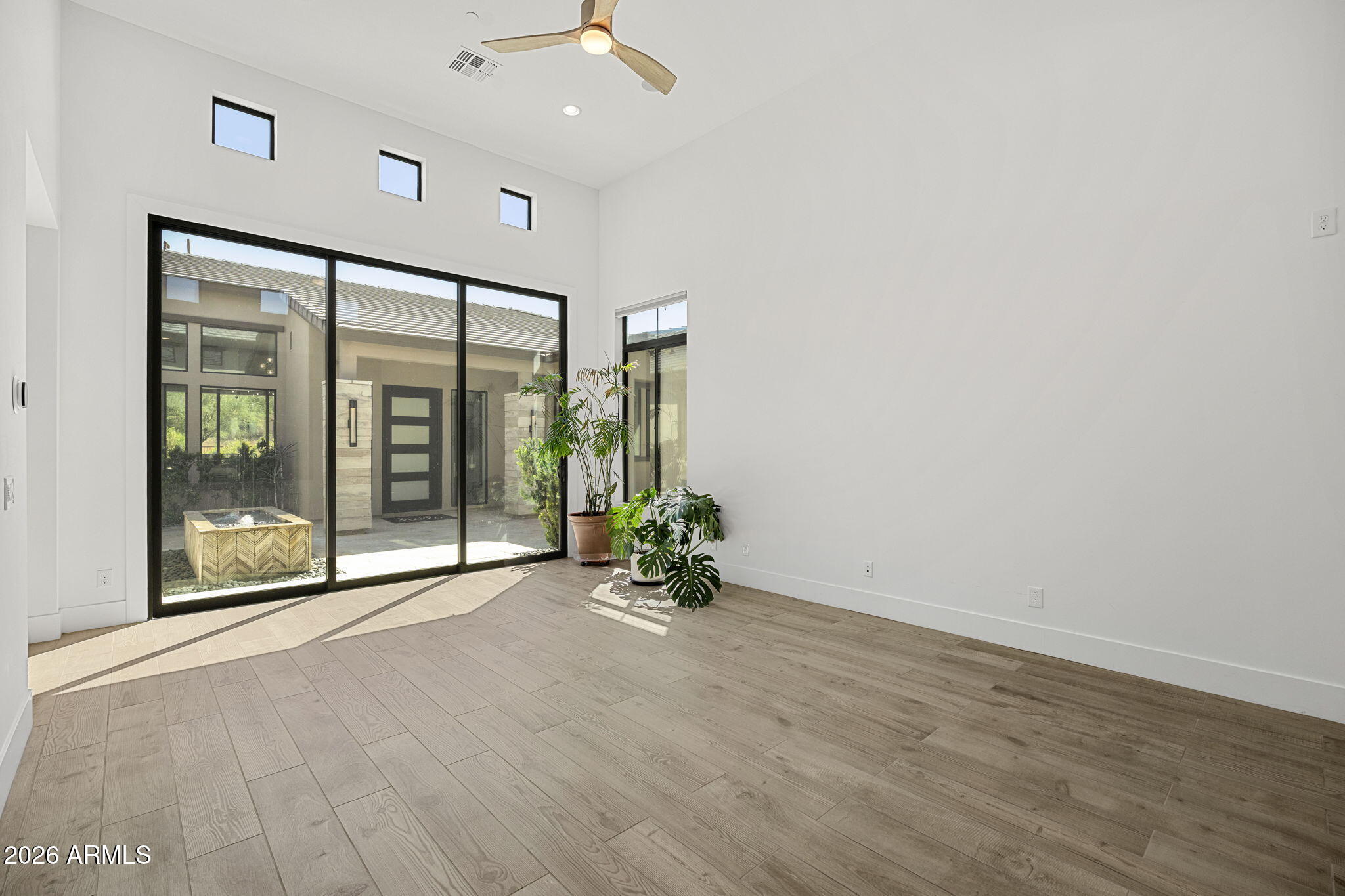 13267 East Ranch Gate Road Scottsdale, AZ 85255 - Photo 50 of 84 a view of an empty room with wooden floor and a window