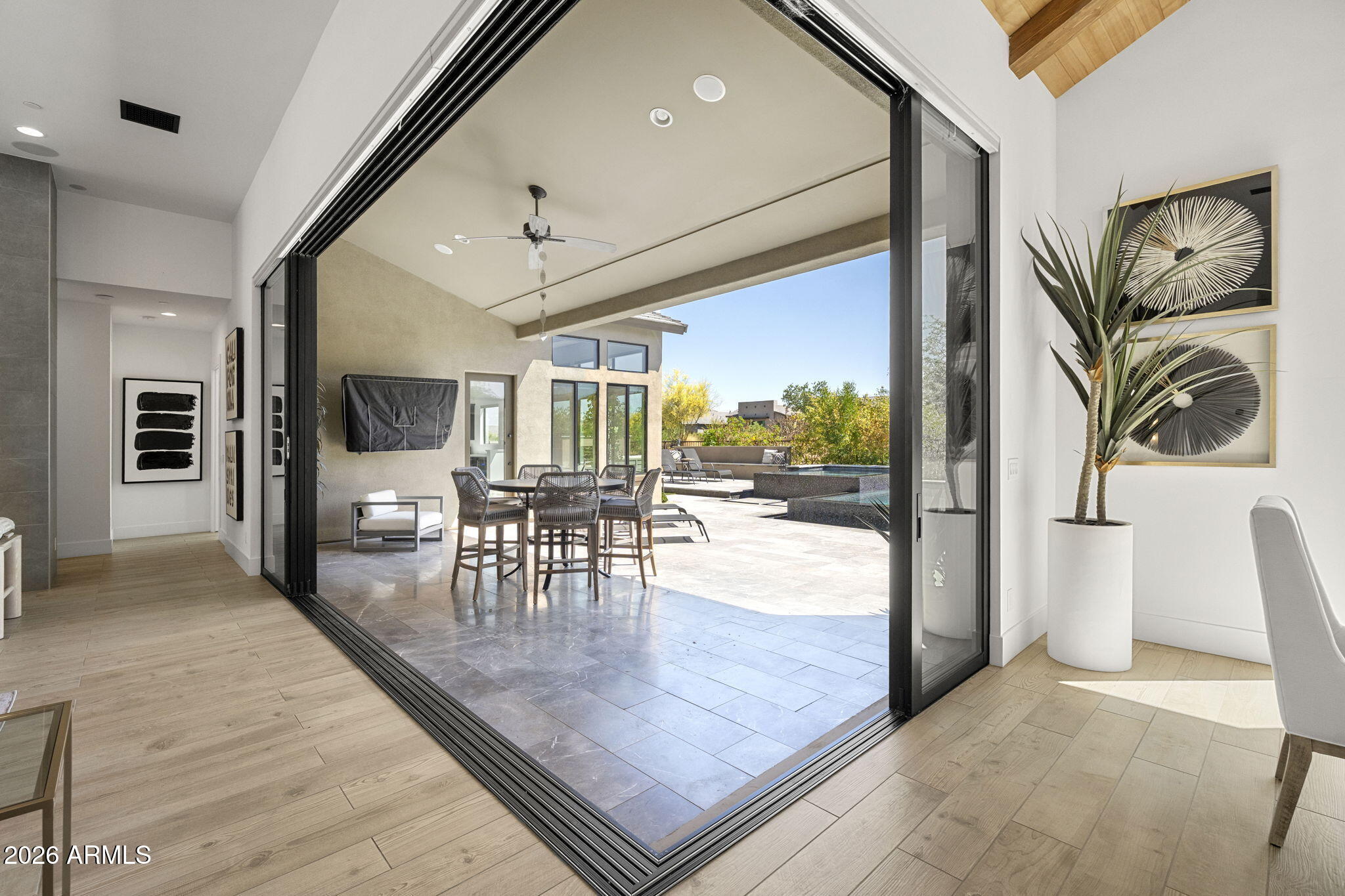13267 East Ranch Gate Road Scottsdale, AZ 85255 - Photo 52 of 84 a dining room with wooden floor and a floor to ceiling window