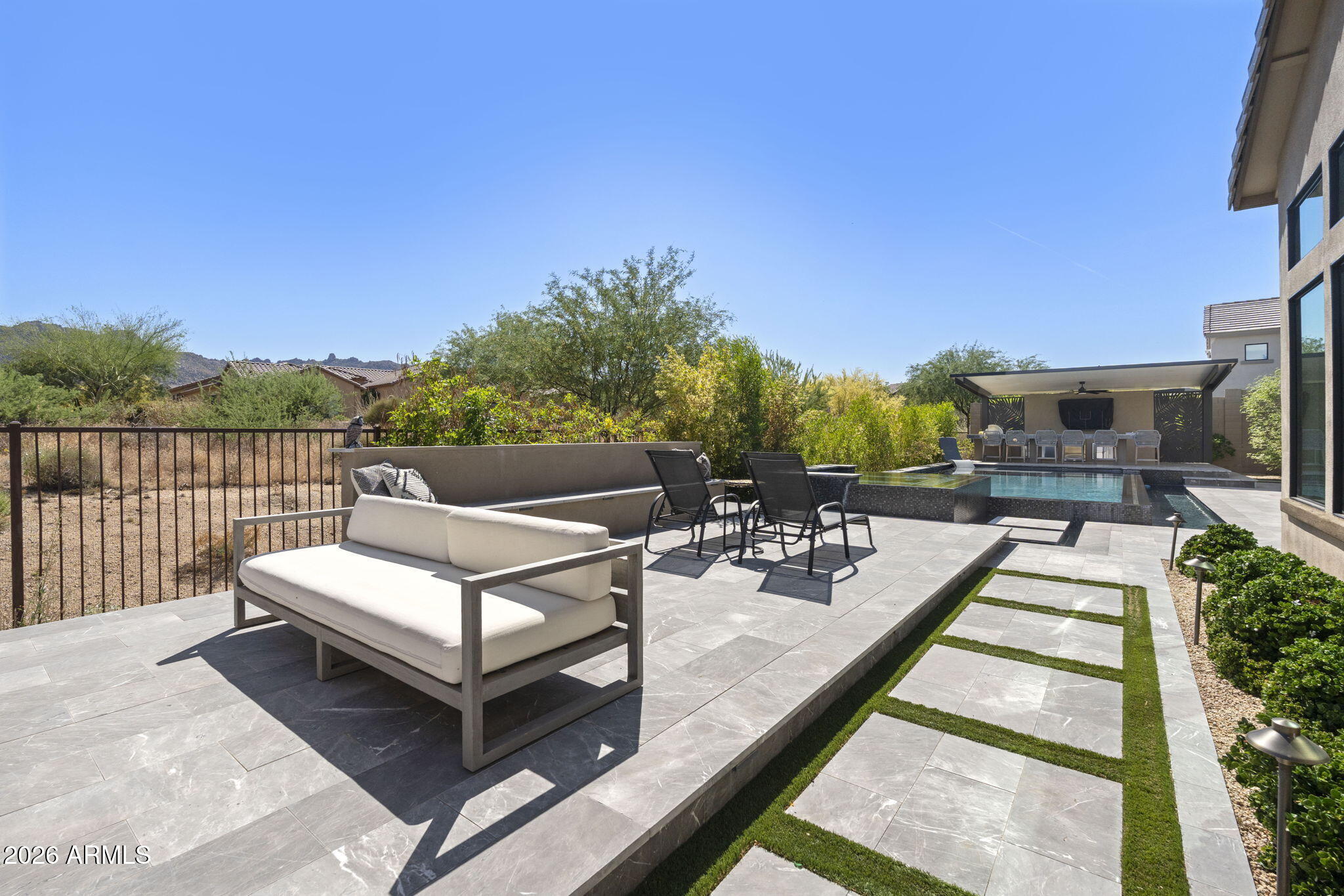 13267 East Ranch Gate Road Scottsdale, AZ 85255 - Photo 67 of 84 a view of a patio with couches table and chairs with wooden floor and fence