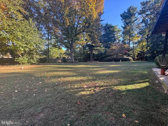 a living room with furniture large window and flat screen tv
