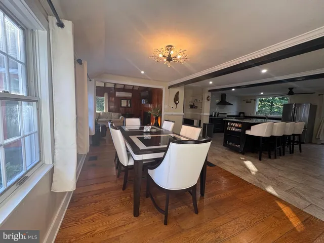 a bedroom with a bed ceiling fan and a wooden floor