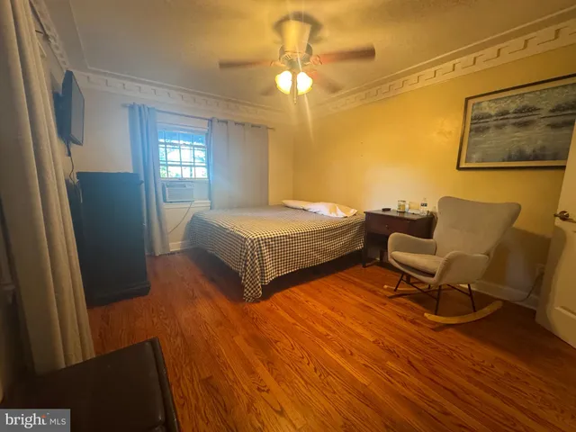 a living room with furniture a flat screen tv and a table