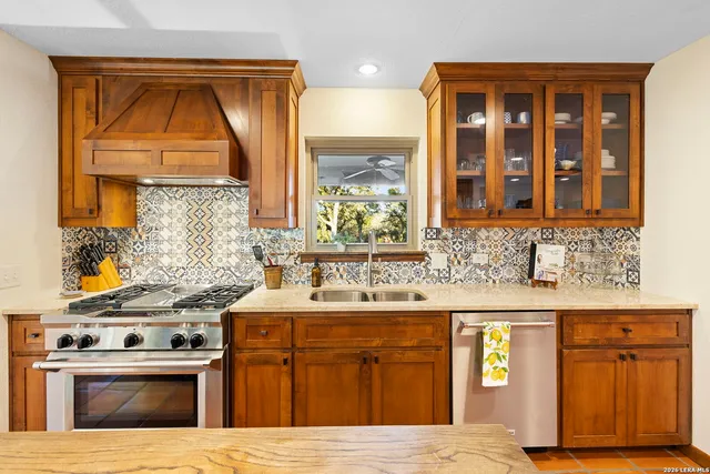 a large kitchen with kitchen island a large window