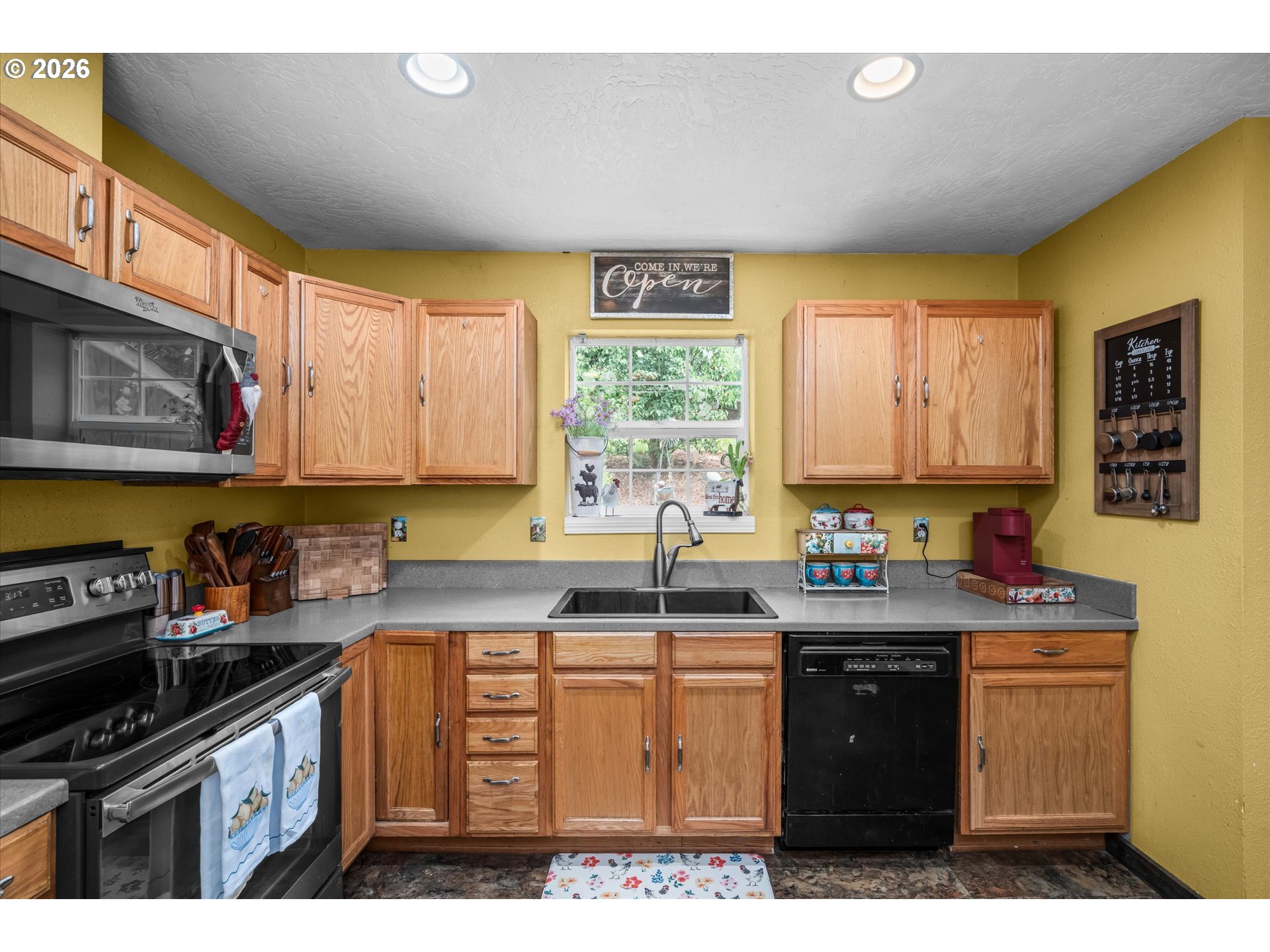 91051 Leashore Drive Vida, OR 97488 - Photo 32 of 36 a kitchen with stainless steel appliances granite countertop a stove a sink dishwasher and cabinets with wooden floor