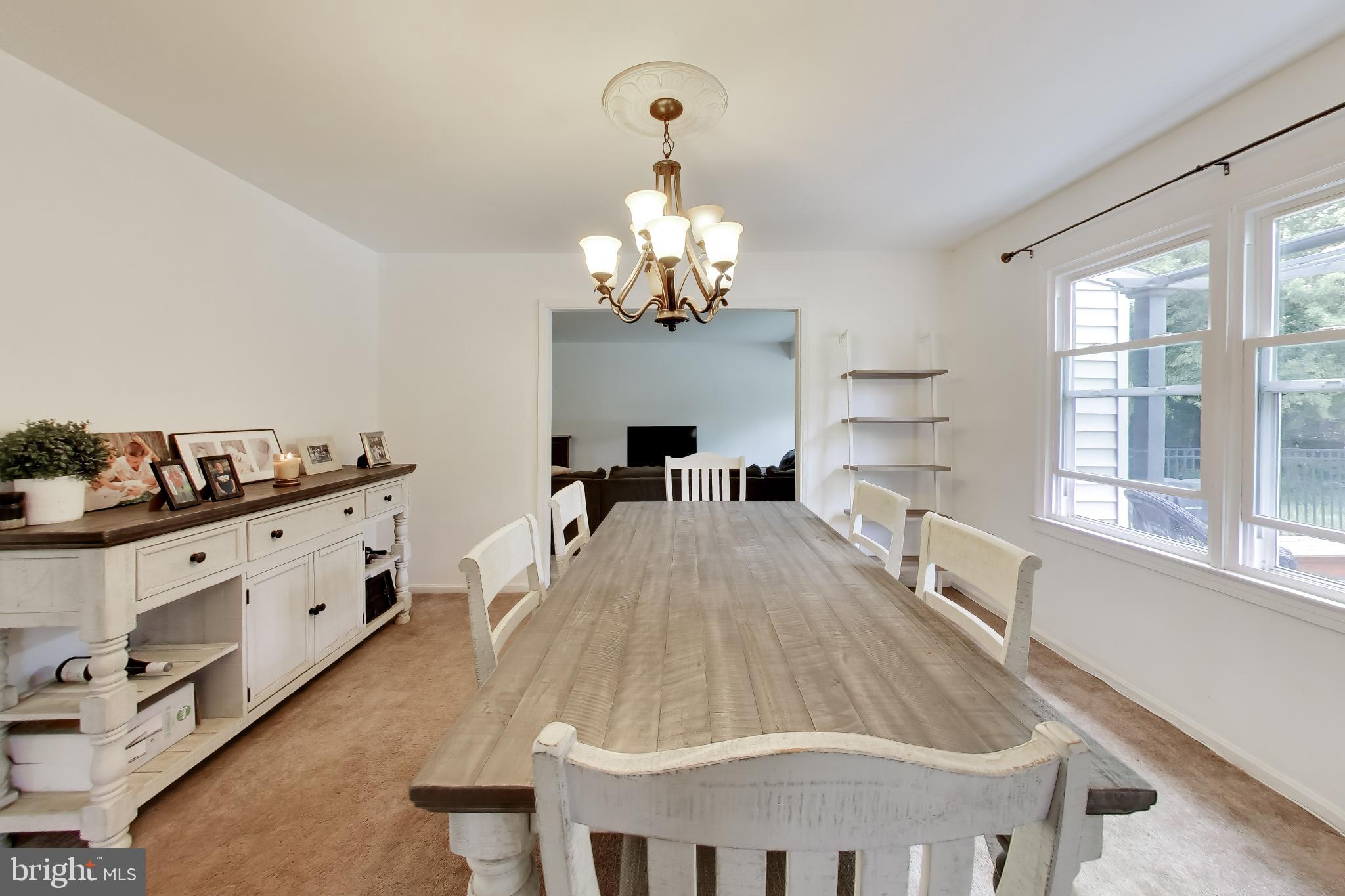 3240 Juniper Lane Huntingtown, MD 20639 - Photo 38 of 48 a large white kitchen with chandelier