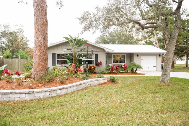 a view of a house with swimming pool and a porch with furniture