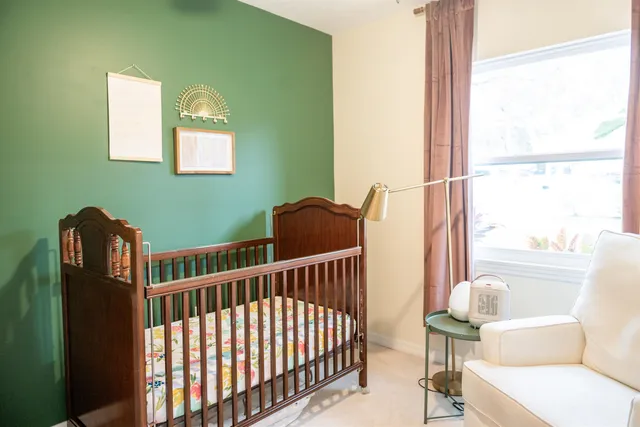 a view of a hallway with white walls and cabinet