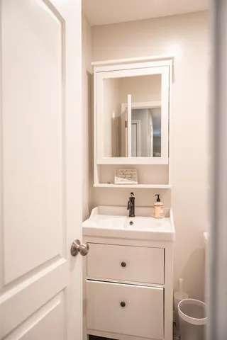 a white toilet sitting next to a bathroom sink and tub