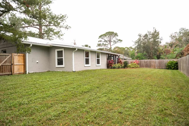 a front view of house with yard and trees