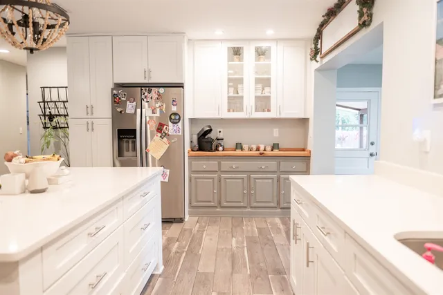a kitchen that has a lot of cabinets a sink and a stove