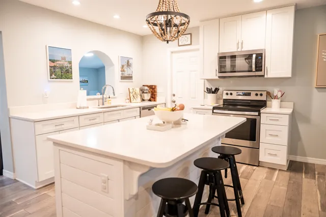 a kitchen with a sink cabinets and wooden floor