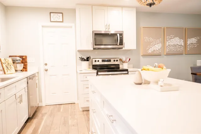 a bathroom with a sink a window and a flat screen tv