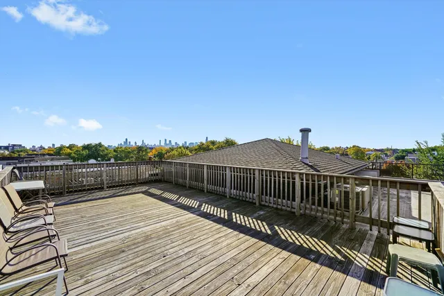 a view of a balcony with wooden floor and city view