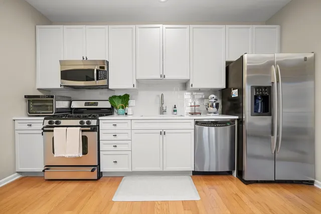 a kitchen with stainless steel appliances a refrigerator stove and microwave