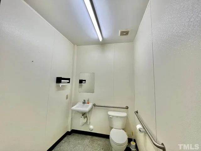 a white toilet sitting next to a shower curtain