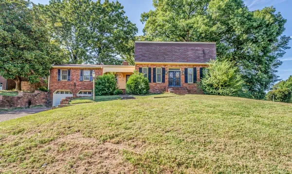 a view of a house with garden and yard