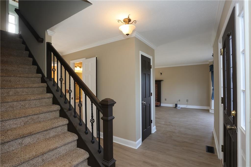 4981 Shallow Ridge Road Northeast Kennesaw, GA 30144 - Photo 11 of 36 a view of a hallway with wooden floor and staircase