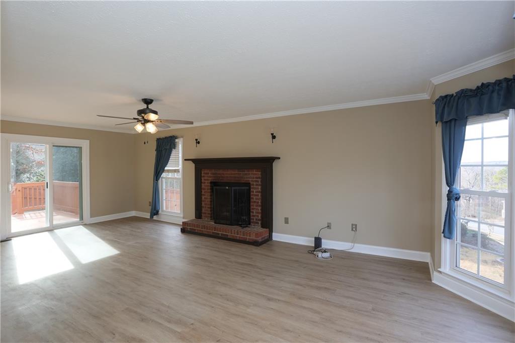 4981 Shallow Ridge Road Northeast Kennesaw, GA 30144 - Photo 12 of 36 wooden floor fireplace and windows in an empty room