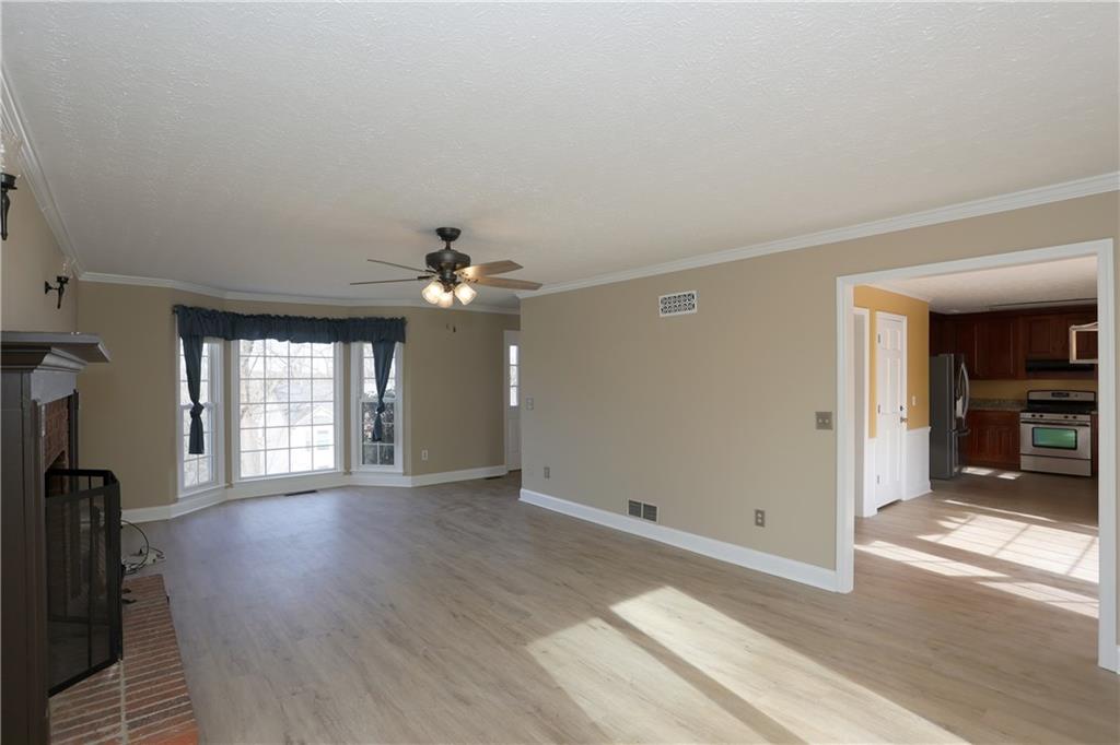 4981 Shallow Ridge Road Northeast Kennesaw, GA 30144 - Photo 13 of 36 wooden floor in an empty room with a window