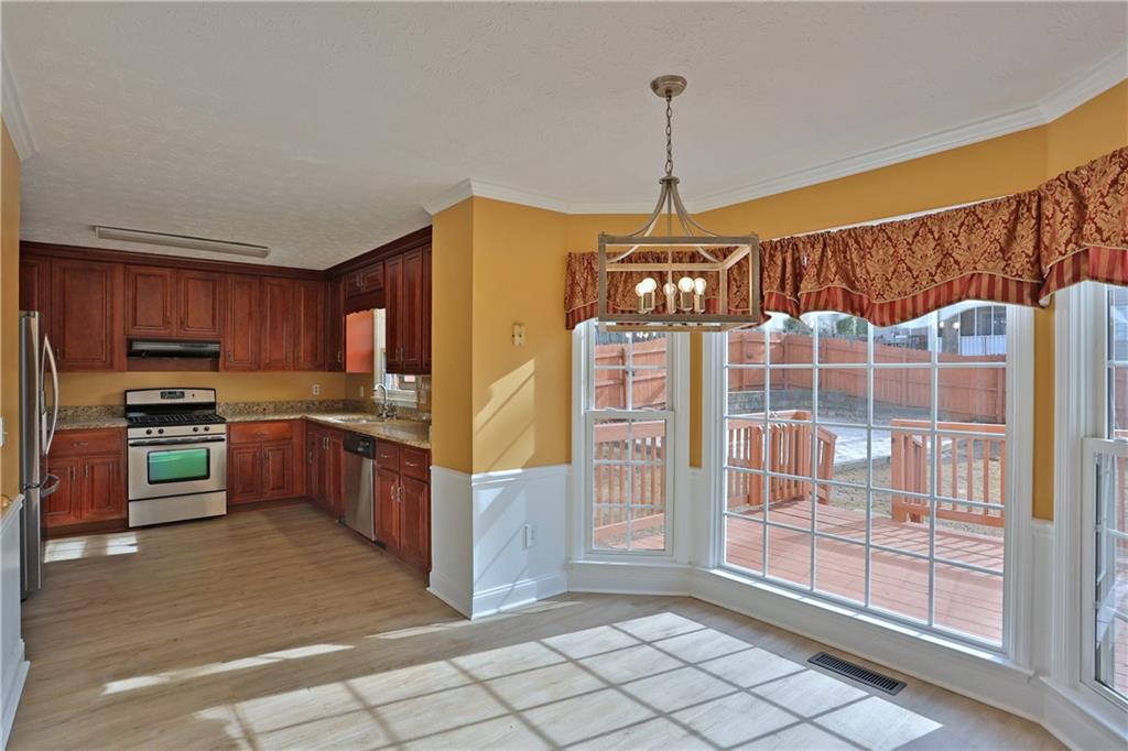 4981 Shallow Ridge Road Northeast Kennesaw, GA 30144 - Photo 15 of 36 a kitchen with stainless steel appliances granite countertop a refrigerator and a sink