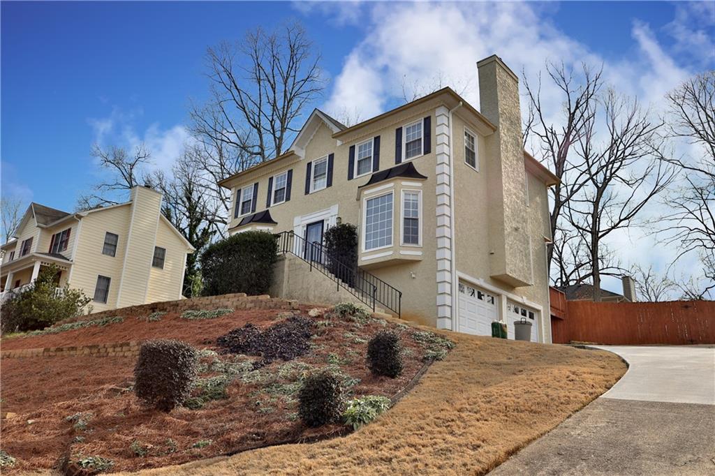 4981 Shallow Ridge Road Northeast Kennesaw, GA 30144 - Photo 2 of 36 a front view of a house with a yard