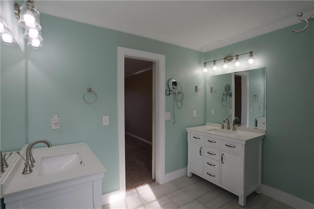 4981 Shallow Ridge Road Northeast Kennesaw, GA 30144 - Photo 25 of 36 a bathroom with a sink vanity and mirror