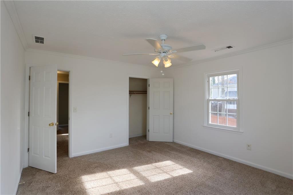 4981 Shallow Ridge Road Northeast Kennesaw, GA 30144 - Photo 30 of 36 an empty room with windows and closet