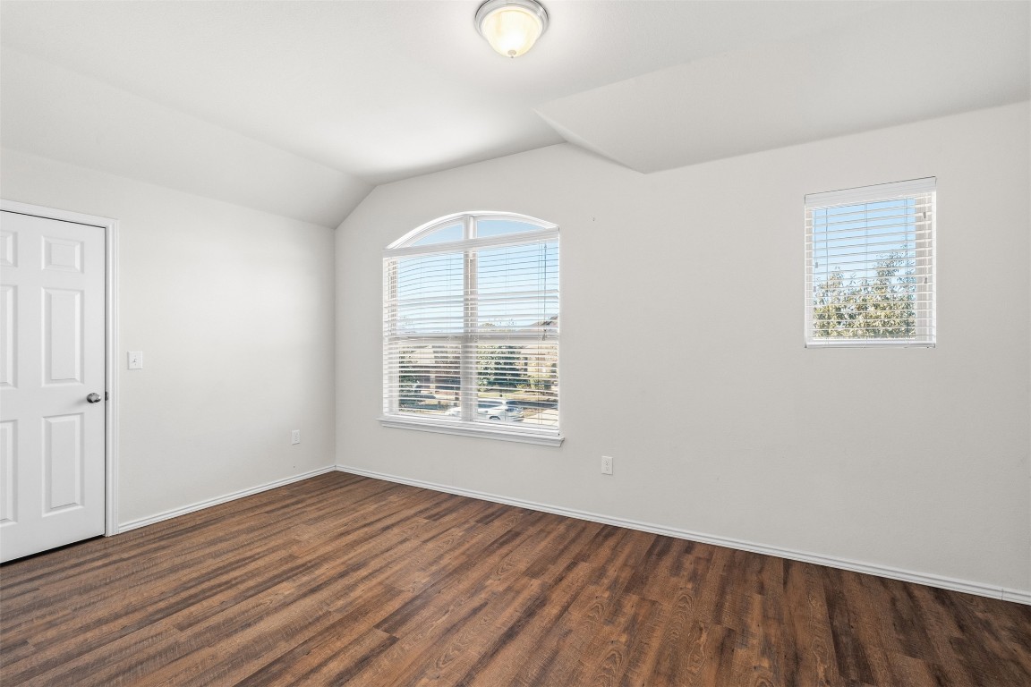 160 Albatross Cove Buda, TX 78610 - Photo 17 of 36 an empty room with wooden floor and windows