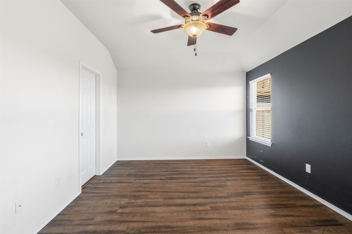160 Albatross Cove Buda, TX 78610 - Photo 19 of 36 an empty room with wooden floor fan and windows