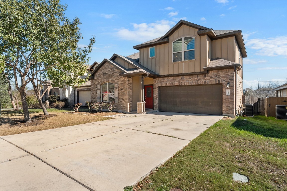 160 Albatross Cove Buda, TX 78610 - Photo 2 of 36 a front view of a house with a yard and garage