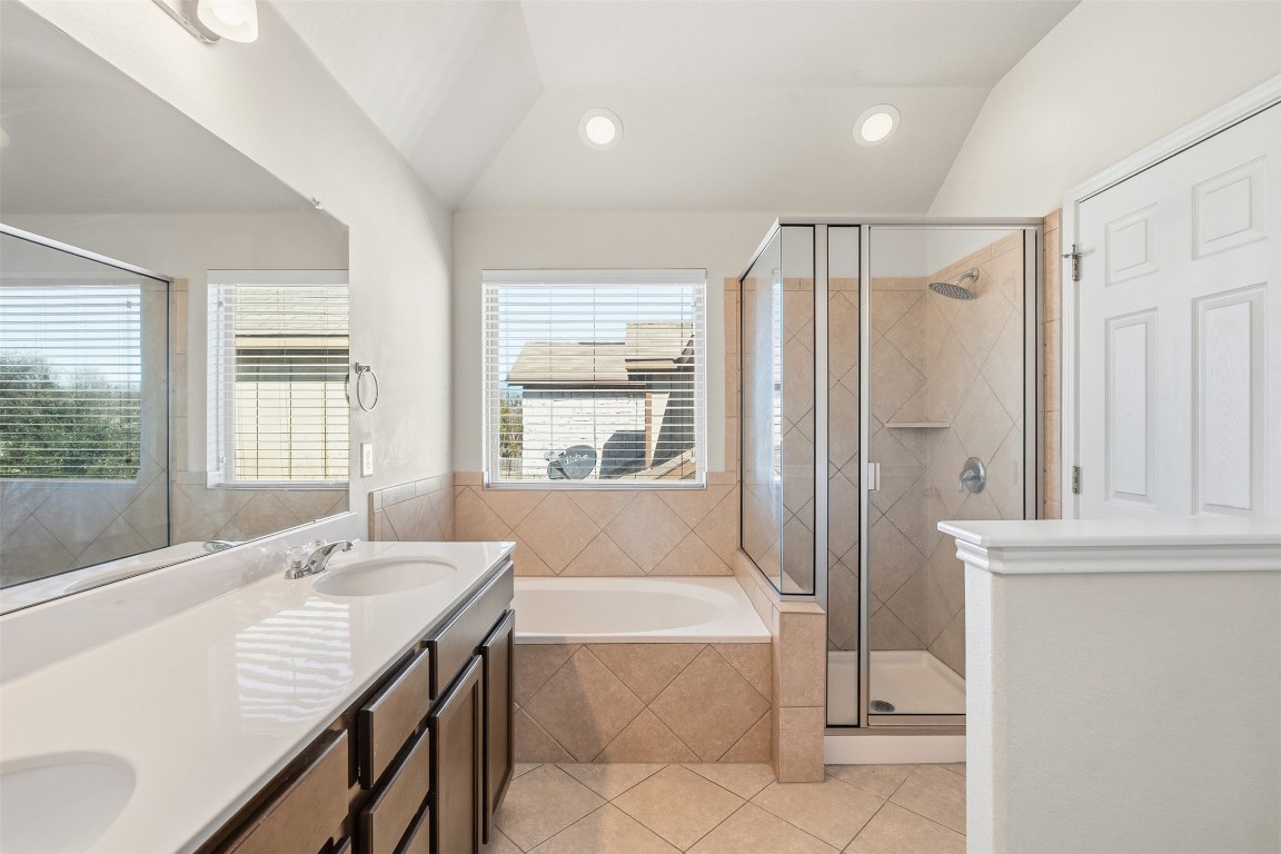 160 Albatross Cove Buda, TX 78610 - Photo 22 of 36 a bathroom with a granite countertop sink and a bathtub