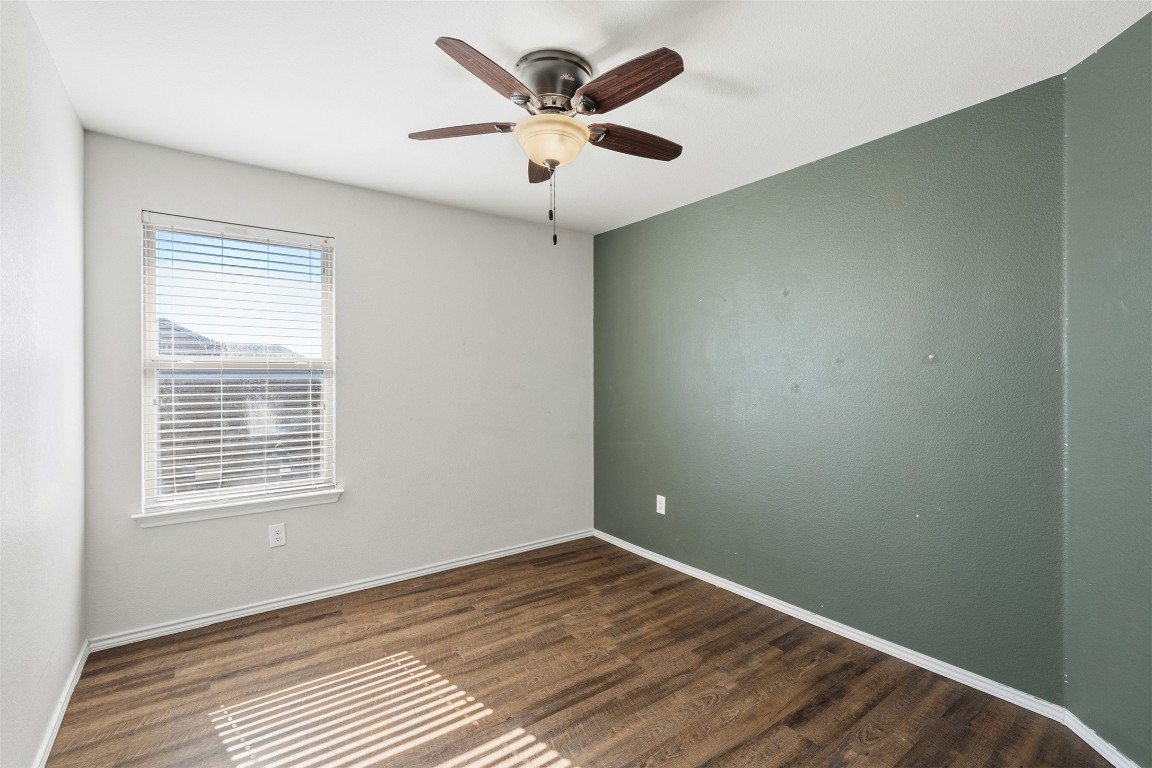160 Albatross Cove Buda, TX 78610 - Photo 25 of 36 an empty room with wooden floor and windows