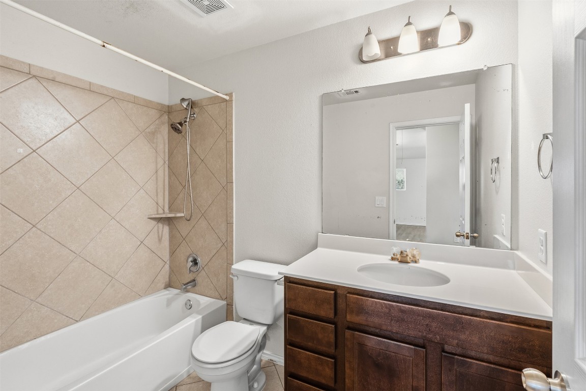 160 Albatross Cove Buda, TX 78610 - Photo 27 of 36 a bathroom with a sink toilet a mirror and shower