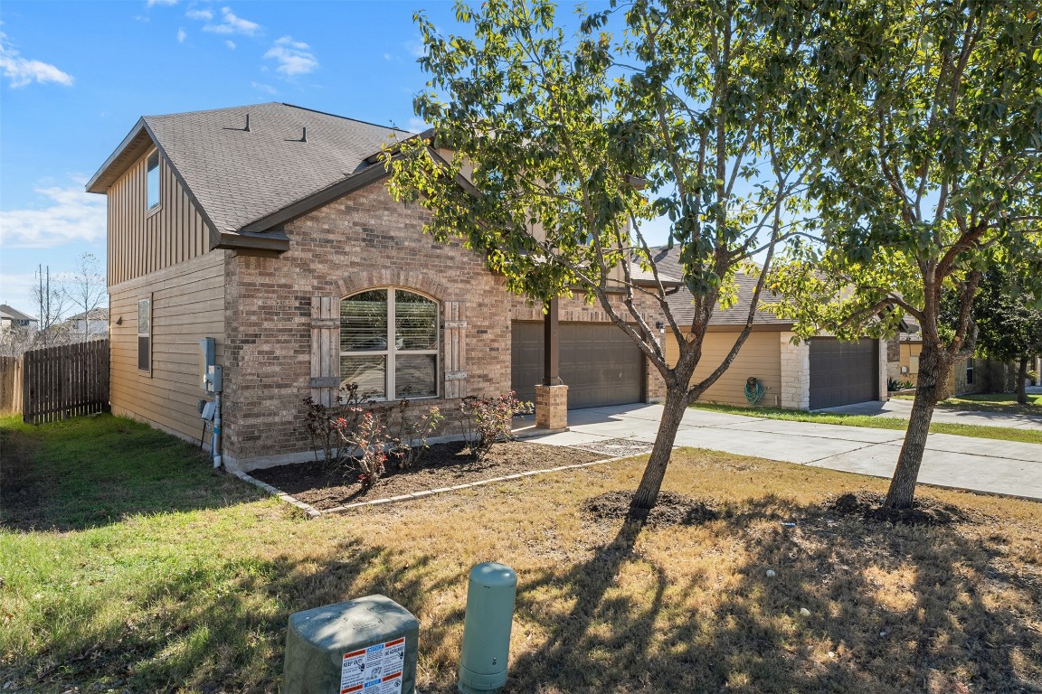 160 Albatross Cove Buda, TX 78610 - Photo 3 of 36 a front view of a house with garden