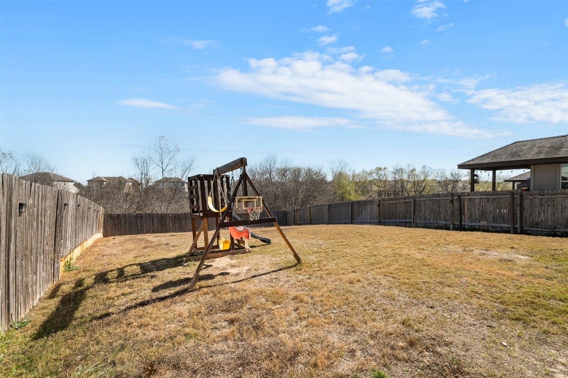 160 Albatross Cove Buda, TX 78610 - Photo 32 of 36 a view of roof deck with a barbeque and wooden fence