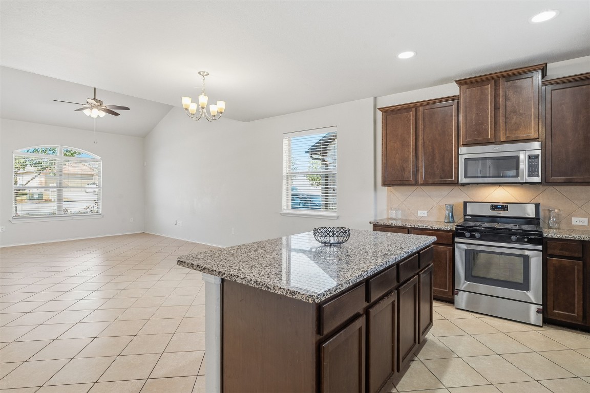 160 Albatross Cove Buda, TX 78610 - Photo 9 of 36 a kitchen that has a sink and a stove top oven