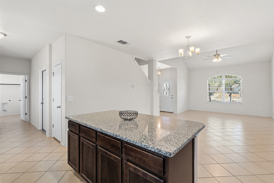 160 Albatross Cove Buda, TX 78610 - Photo 36 of 36 an open kitchen with granite countertop a sink and cabinets