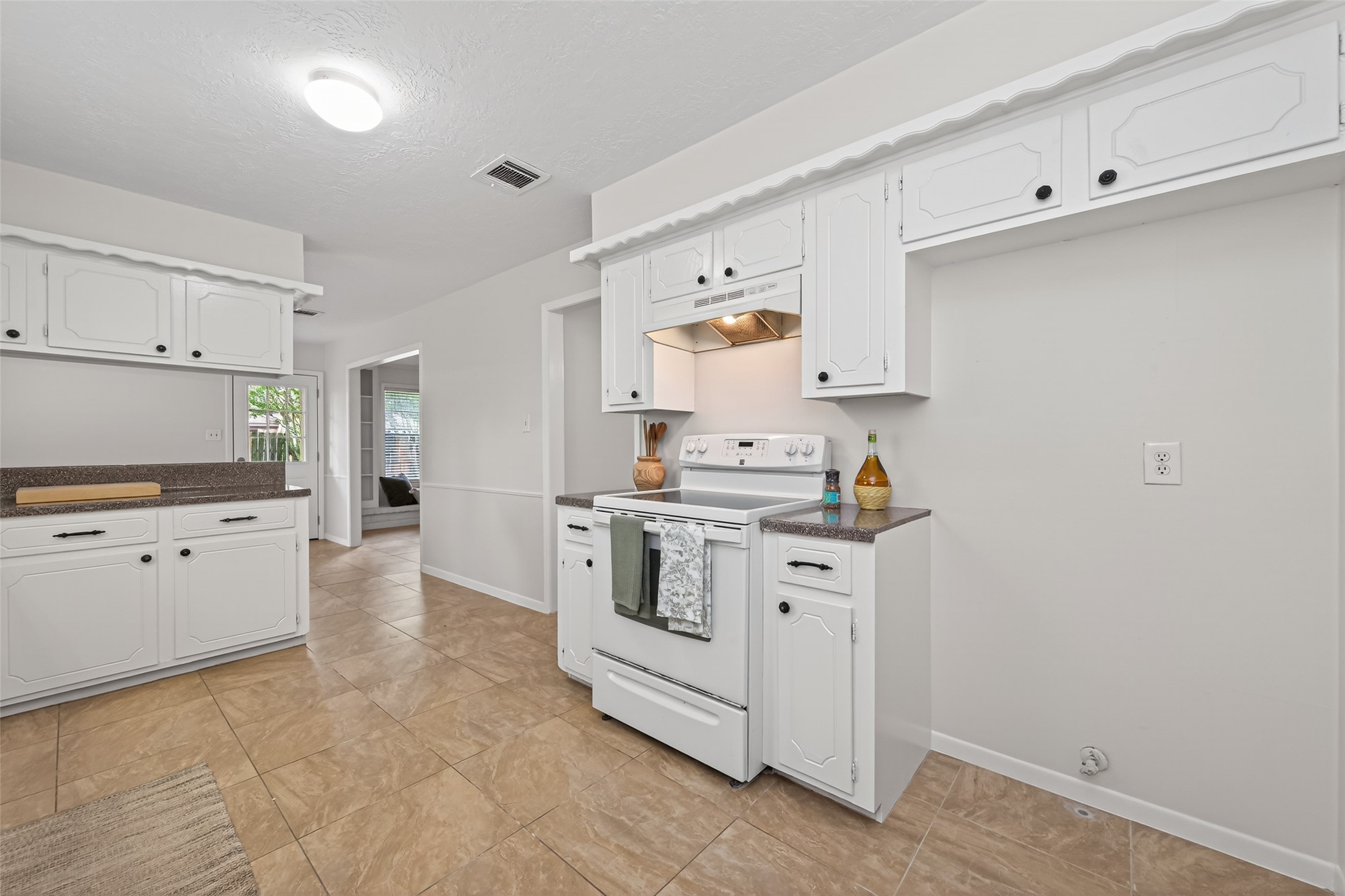 23919 Farm Hill Drive Spring, TX 77373 - Photo 20 of 41 a kitchen with granite countertop white cabinets and white appliances