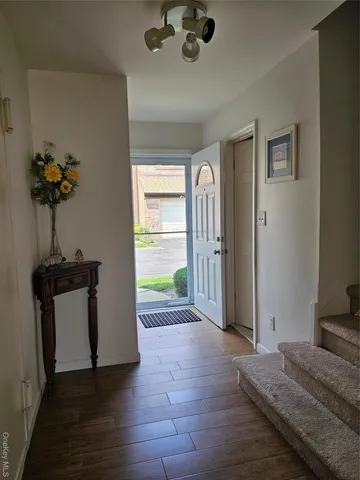 a view of a hallway to a livingroom with furniture