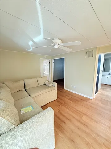 a kitchen with stainless steel appliances granite countertop a sink a stove and wooden floors