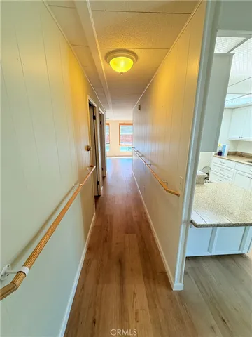 wooden floor in an empty room with a mirror