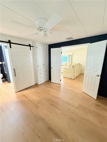 a bathroom with a granite countertop sink a toilet and mirror